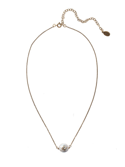 Estella Pendant Necklace - NEV104AGMDP - <p>A single freshwater pearl hosts a metallic star embellished with sparkling crystals. These delicate details sit at the base of a thin adjustable chain, secured with a spring ring clasp. From Sorrelli's Modern Pearl collection in our Antique Gold-tone finish.</p>