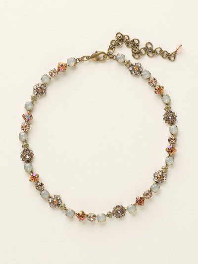 Classic Floral Tennis Necklace - NBE2AGDS - <p>Put an extra spring in your step! This classic necklace features a combination of round and floral cluster crystals to add a sweet romantic touch to your everyday look. From Sorrelli's Desert Sun collection in our Antique Gold-tone finish.</p>