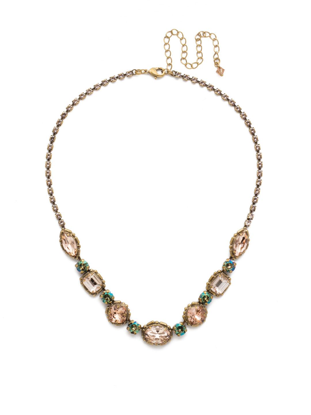 Cardoon Tennis Necklace - NDX7AGSTN - <p>A classic pattern comprised of a central oval crystal followed by cushion cut, emerald cut and navette stones, each separated with a shimmering round crystal. A rhinestone chain gives this necklace all-around allure From Sorrelli's Sandstone collection in our Antique Gold-tone finish.</p>