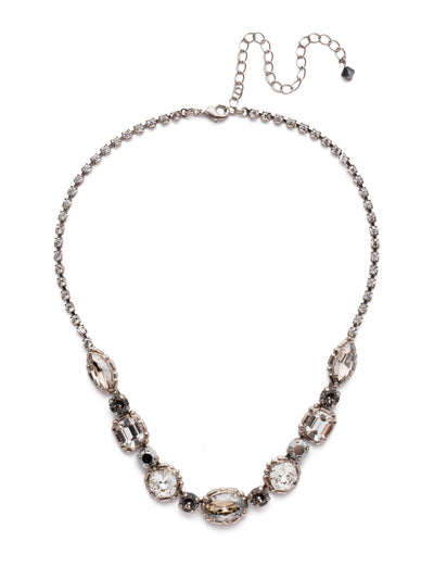 Cardoon Tennis Necklace - NDX7ASCRO - <p>A classic pattern comprised of a central oval crystal followed by cushion cut, emerald cut and navette stones, each separated with a shimmering round crystal. A rhinestone chain gives this necklace all-around allure From Sorrelli's Crystal Rock collection in our Antique Silver-tone finish.</p>