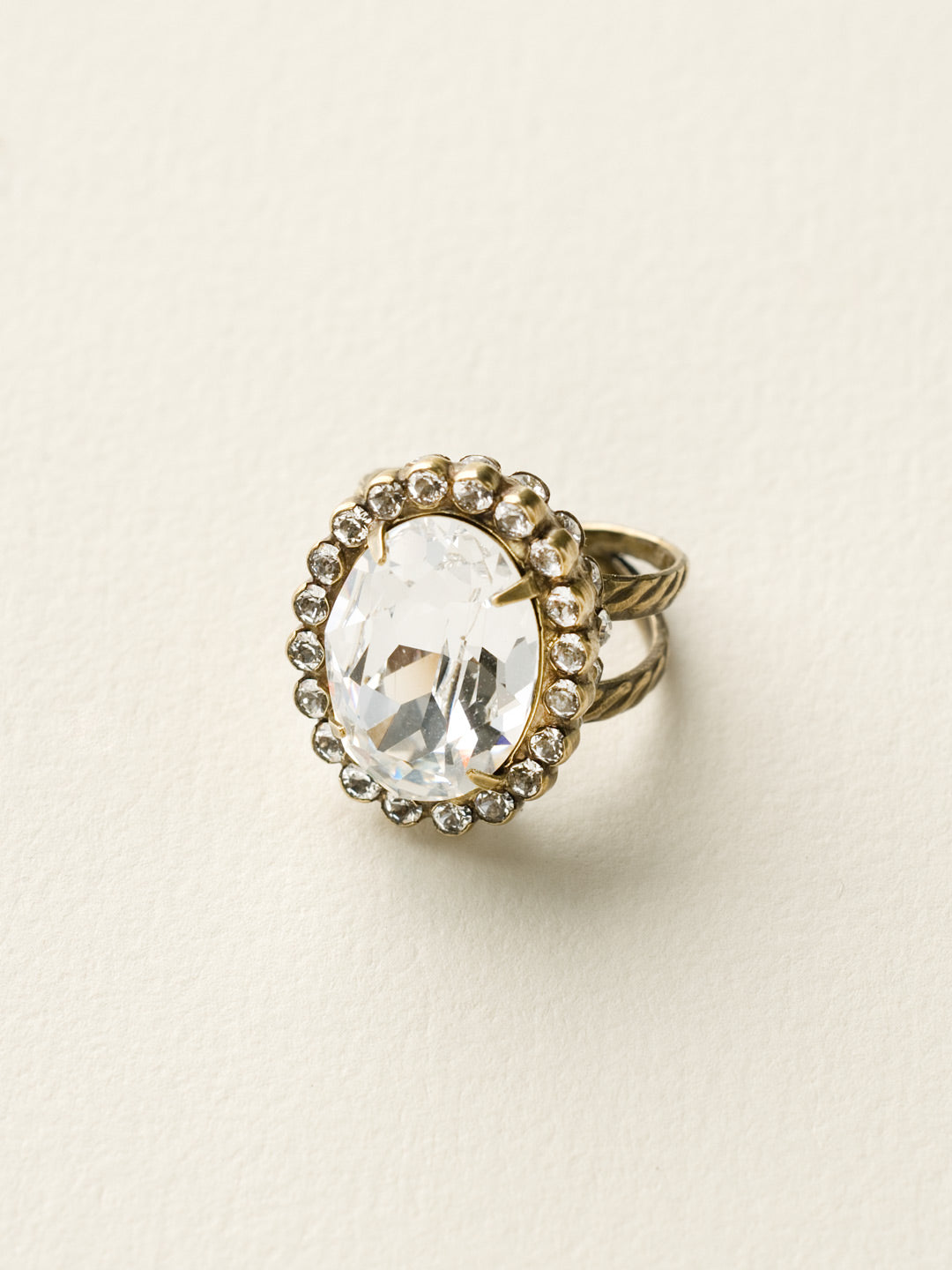 Glamorous Oval-Cut Cocktail Ring - RBT68AGCCL - <p>A jewelry collection must! This glamorous ring features a bold oval cut center crystal surrounded by crystal accents that sits on a braided band to create an antique classic. Ring size: 7 (US) From Sorrelli's Crystal Clear collection in our Antique Gold-tone finish.</p>