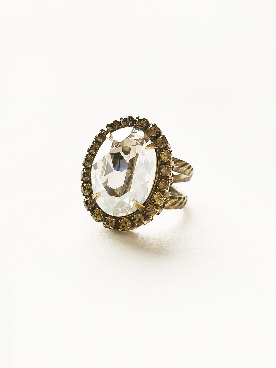 Glamorous Oval-Cut Cocktail Ring - RBT68AGCN - <p>A jewelry collection must! This glamorous ring features a bold oval cut center crystal surrounded by crystal accents that sits on a braided band to create an antique classic. Ring size: 7 (US) From Sorrelli's City Neutral collection in our Antique Gold-tone finish.</p>