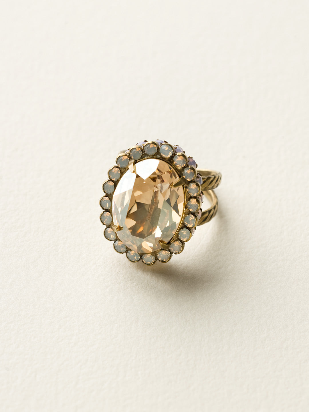 Glamorous Oval-Cut Cocktail Ring - RBT68AGROW - <p>A jewelry collection must! This glamorous ring features a bold oval cut center crystal surrounded by crystal accents that sits on a braided band to create an antique classic. Ring size: 7 (US) From Sorrelli's Rose Water collection in our Antique Gold-tone finish.</p>