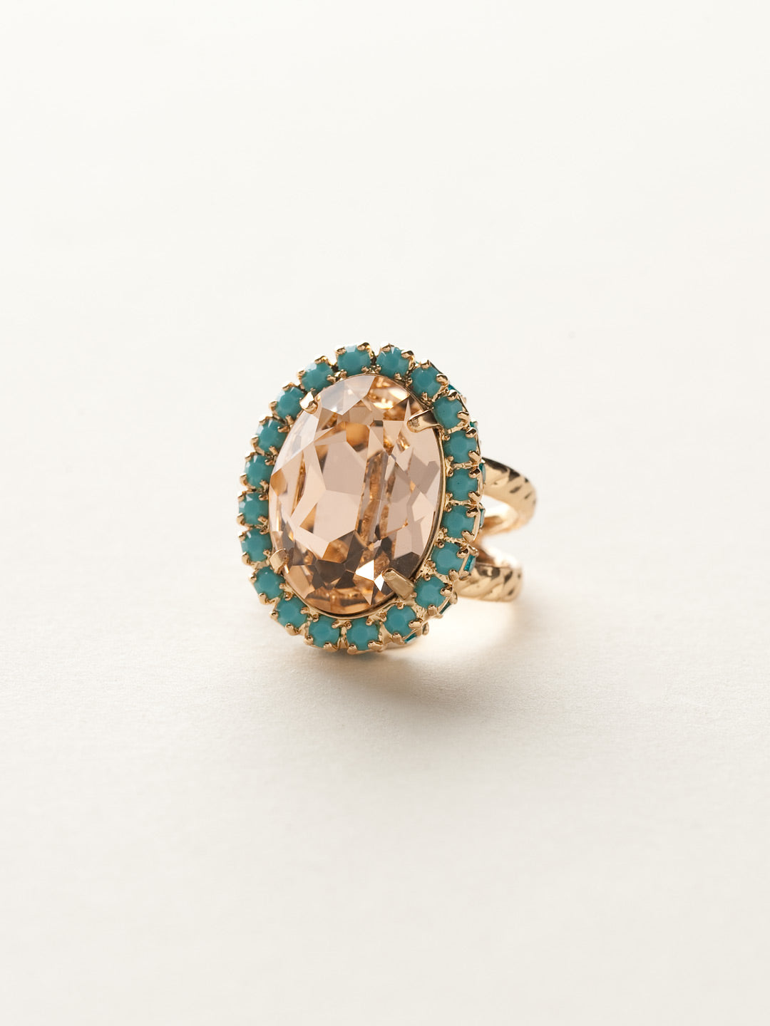 Glamorous Oval-Cut Cocktail Ring - RBT68BGCCO - <p>A jewelry collection must! This glamorous ring features a bold oval cut center crystal surrounded by crystal accents that sits on a braided band to create an antique classic. Ring size: 7 (US) From Sorrelli's Caribbean Coral collection in our Bright Gold-tone finish.</p>