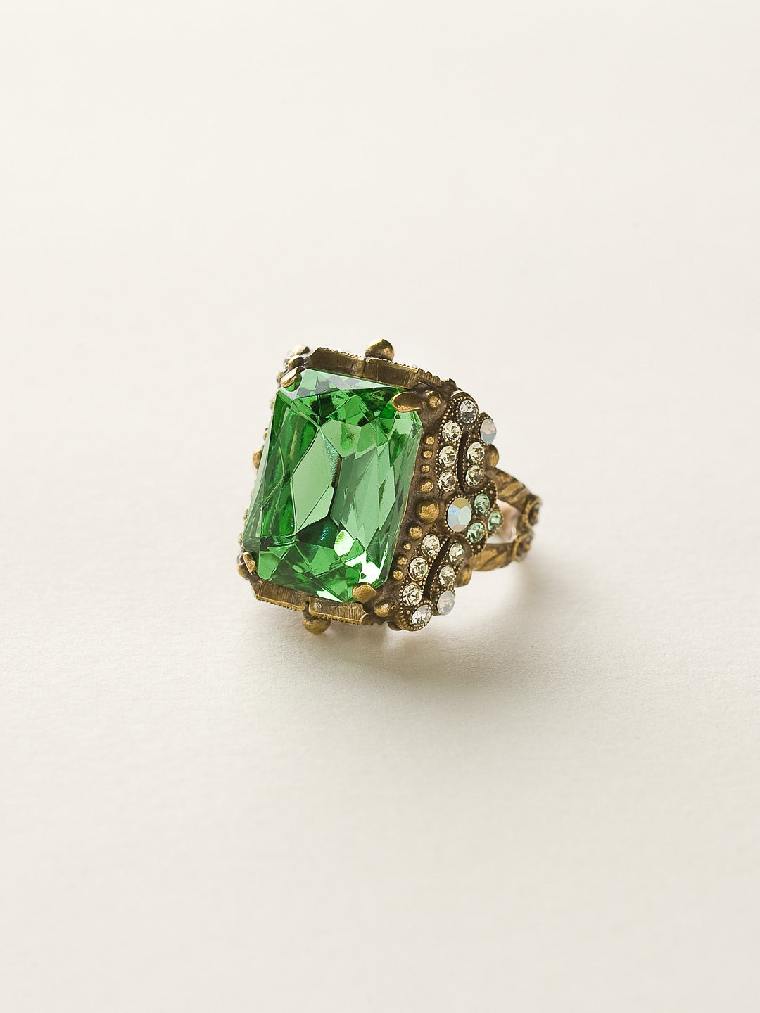 Snowflake Cocktail Ring - RCK2AGGA - <p>All around glitz and glam! This ornate cocktail ring gleams at every angle. With its elegant cushion-cut octagon crystal, you're sure to attract the eyes of many. Ring size: 7 (US) From Sorrelli's Green Apple collection in our Antique Gold-tone finish.</p>