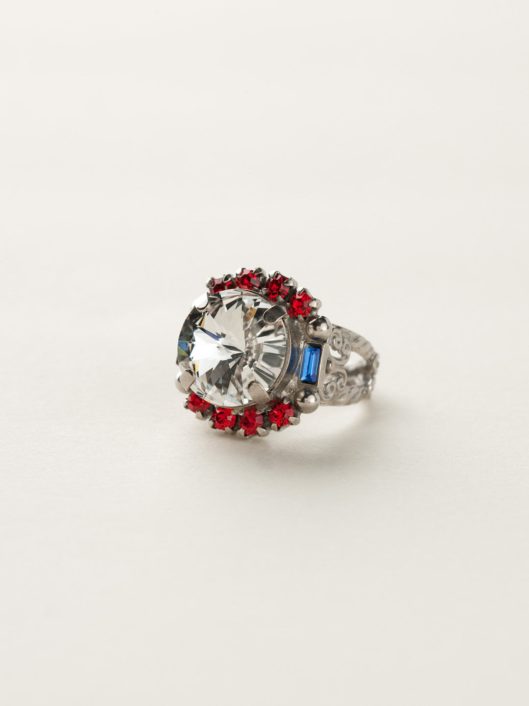 Round Crystal Encrusted Cocktail Ring - RCQ43ASUSA - <p>A large round gemstone surrounded by petite round crystals works as the focal point of this cocktail ring. Which is further accented by an ornate decorative band. Ring size: 7 (US) From Sorrelli's Stars and Stripes collection in our Antique Silver-tone finish.</p>