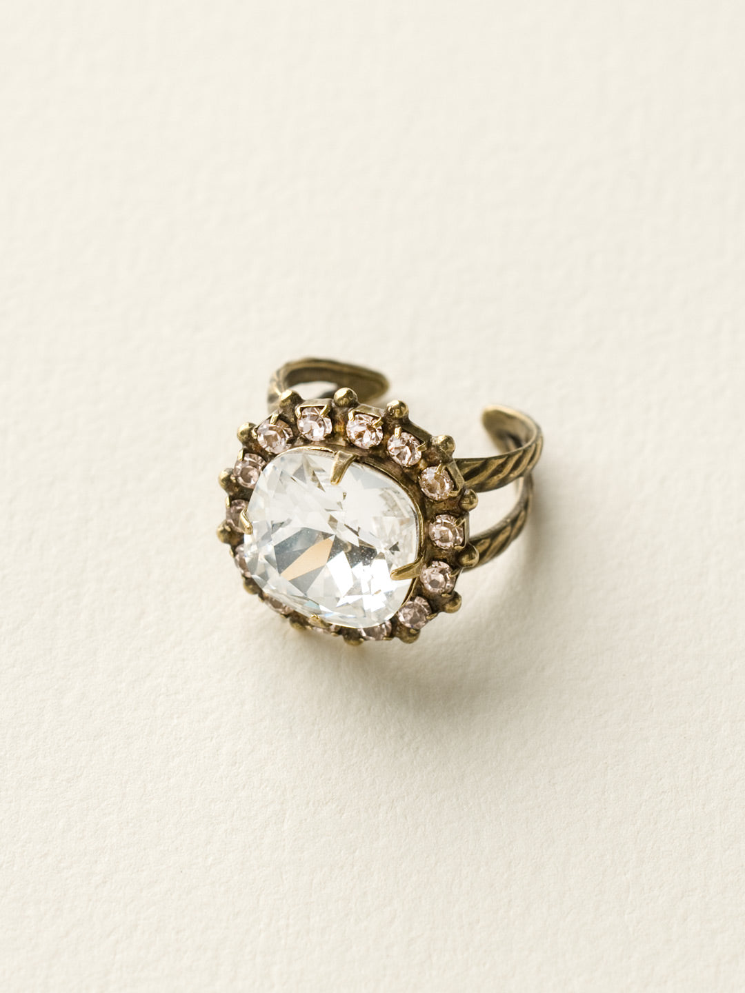 Cushion-Cut Cocktail Ring - RCR112AGCCL - <p>Simply elegant! This classic ring features a central faceted cushion-cut crystal encircled by a row of small round gemstones. Ring size: 7 (US) From Sorrelli's Crystal Clear collection in our Antique Gold-tone finish.</p>